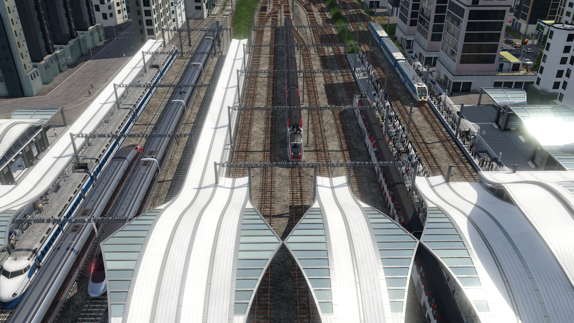 Transport Fever 2公式紹介画面：大きな駅を都市の中へ組み込む